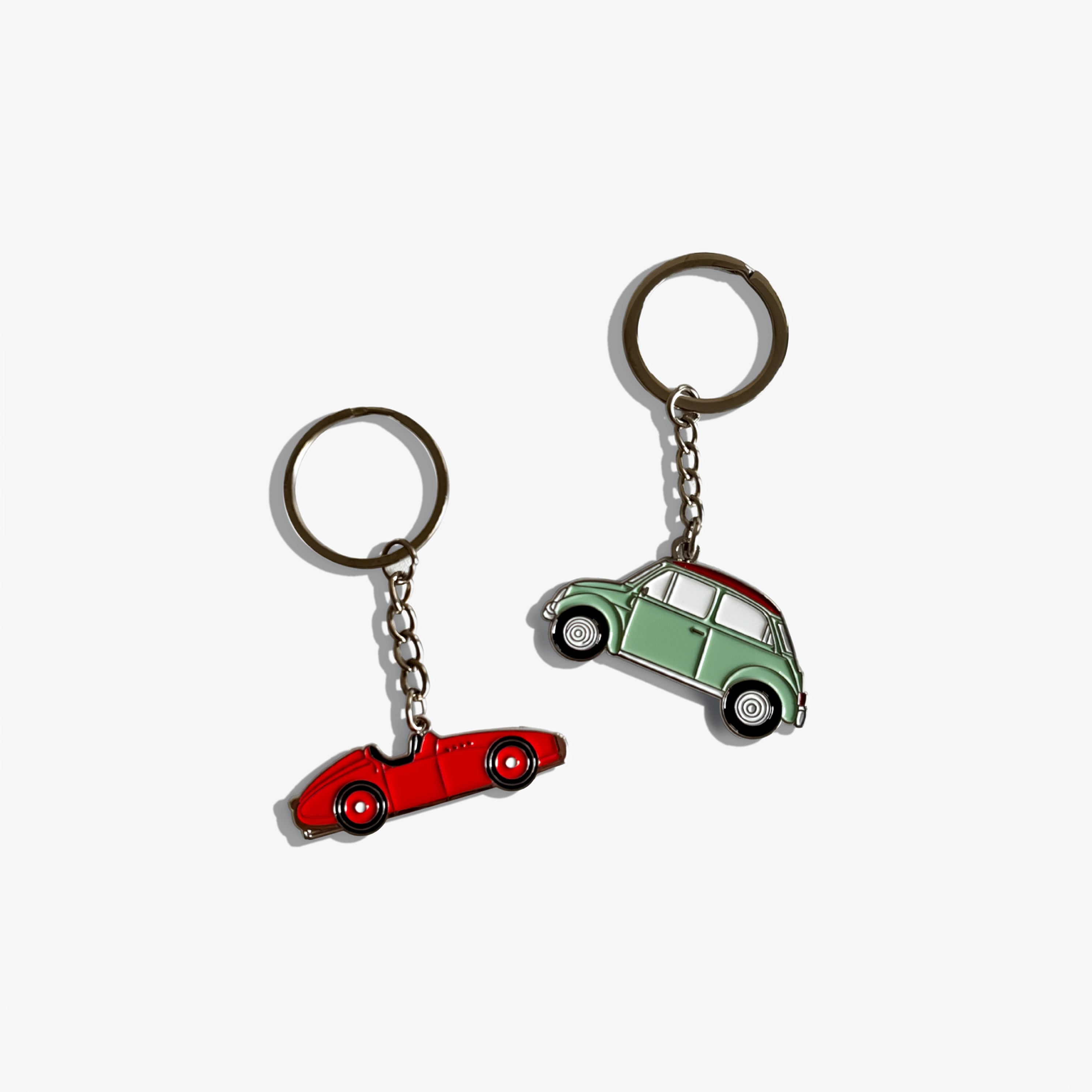 Automobile keychain set with red and green car charms, metal rings and chains