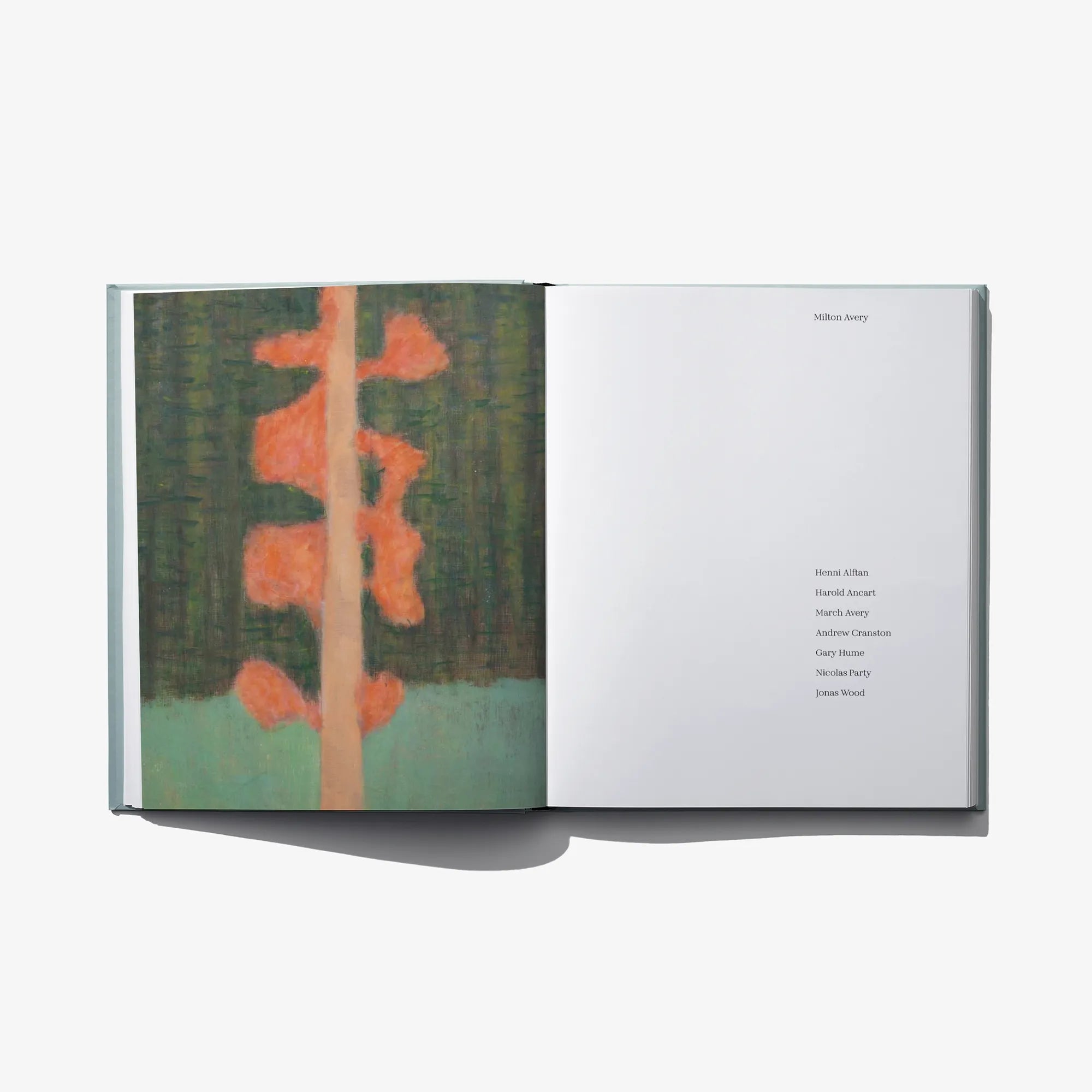 Open art book with green-orange abstract tree artwork on left and text page on right