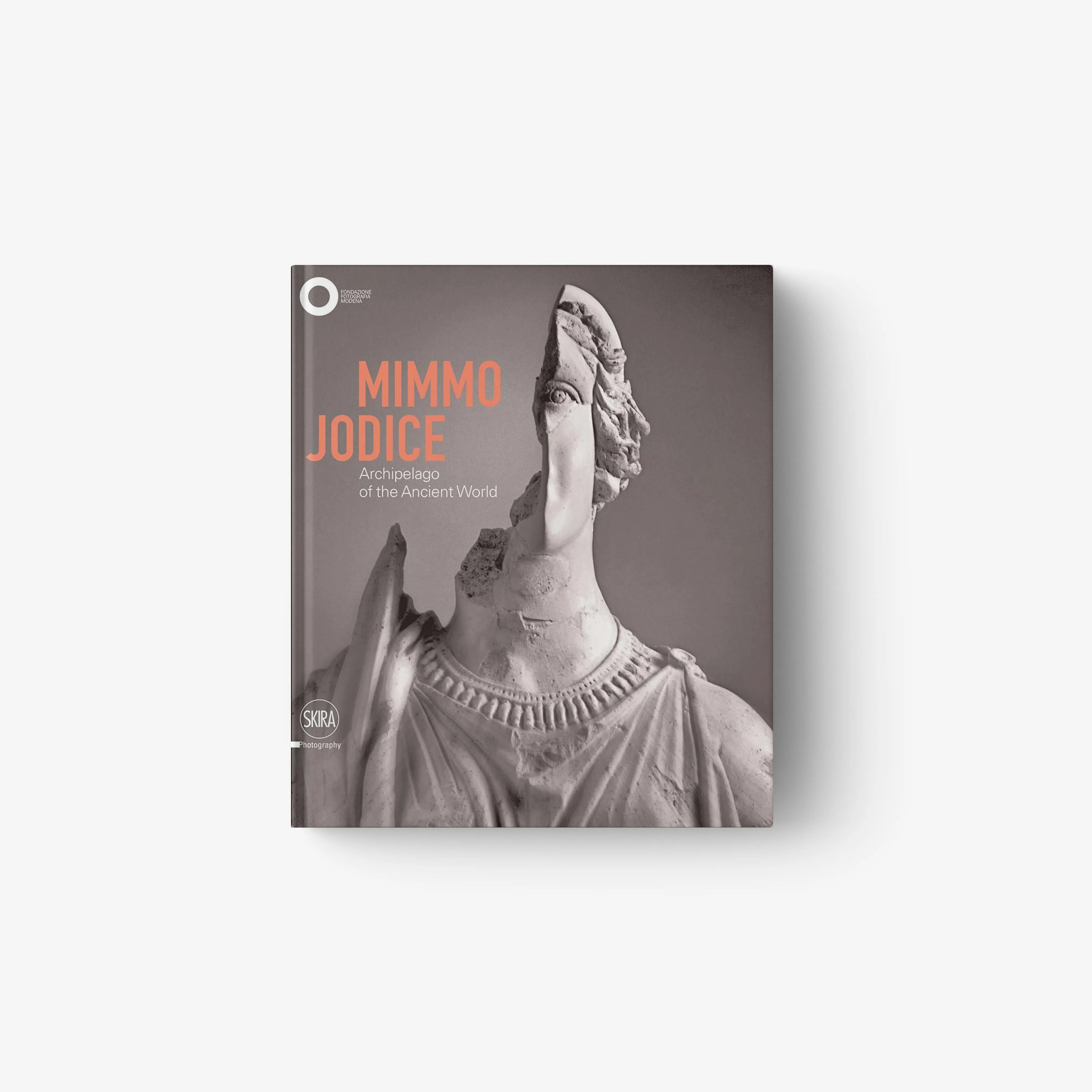 Hardcover art book with grayscale statue figure and orange title lettering