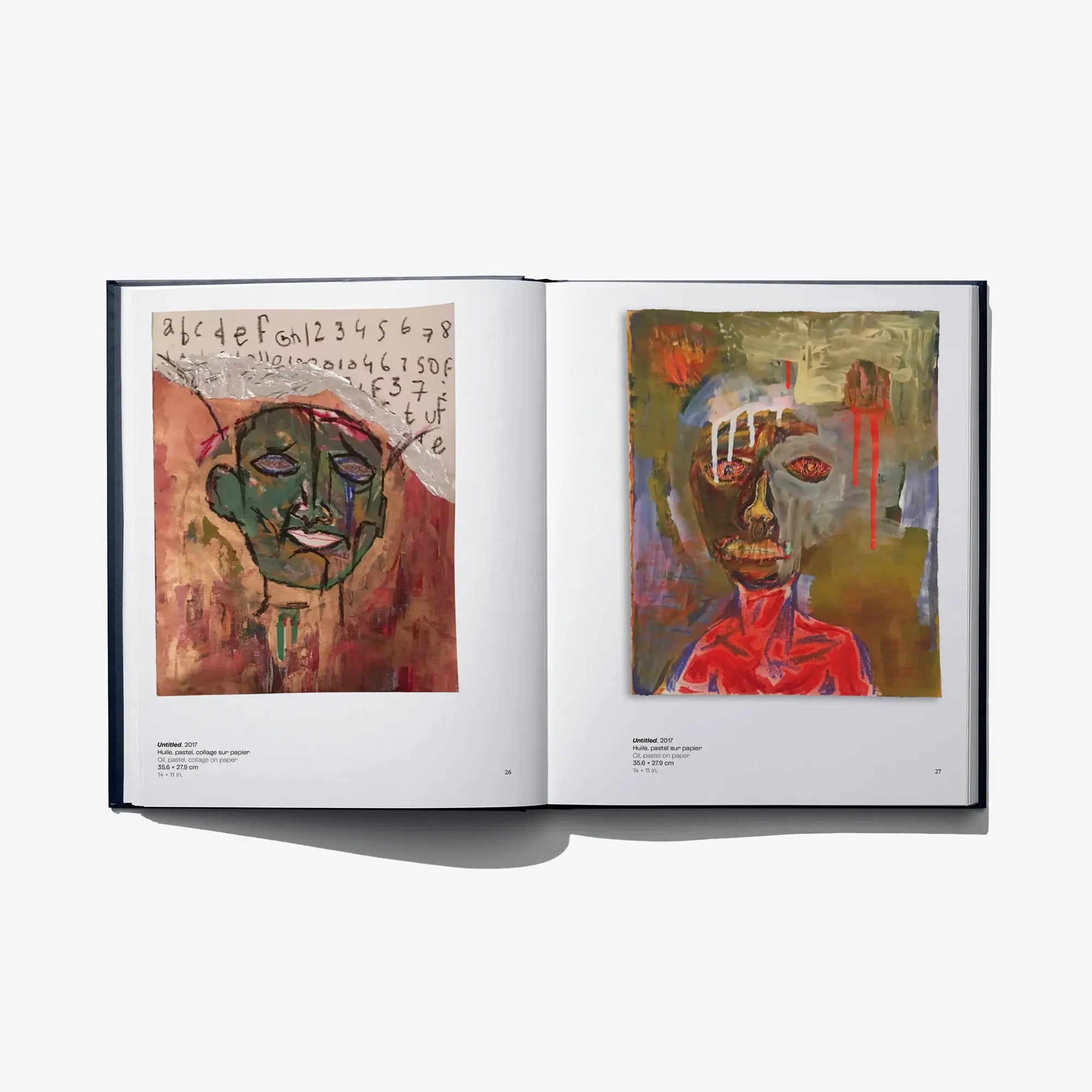 Open art book spread with two colorful abstract faces on left and right pages