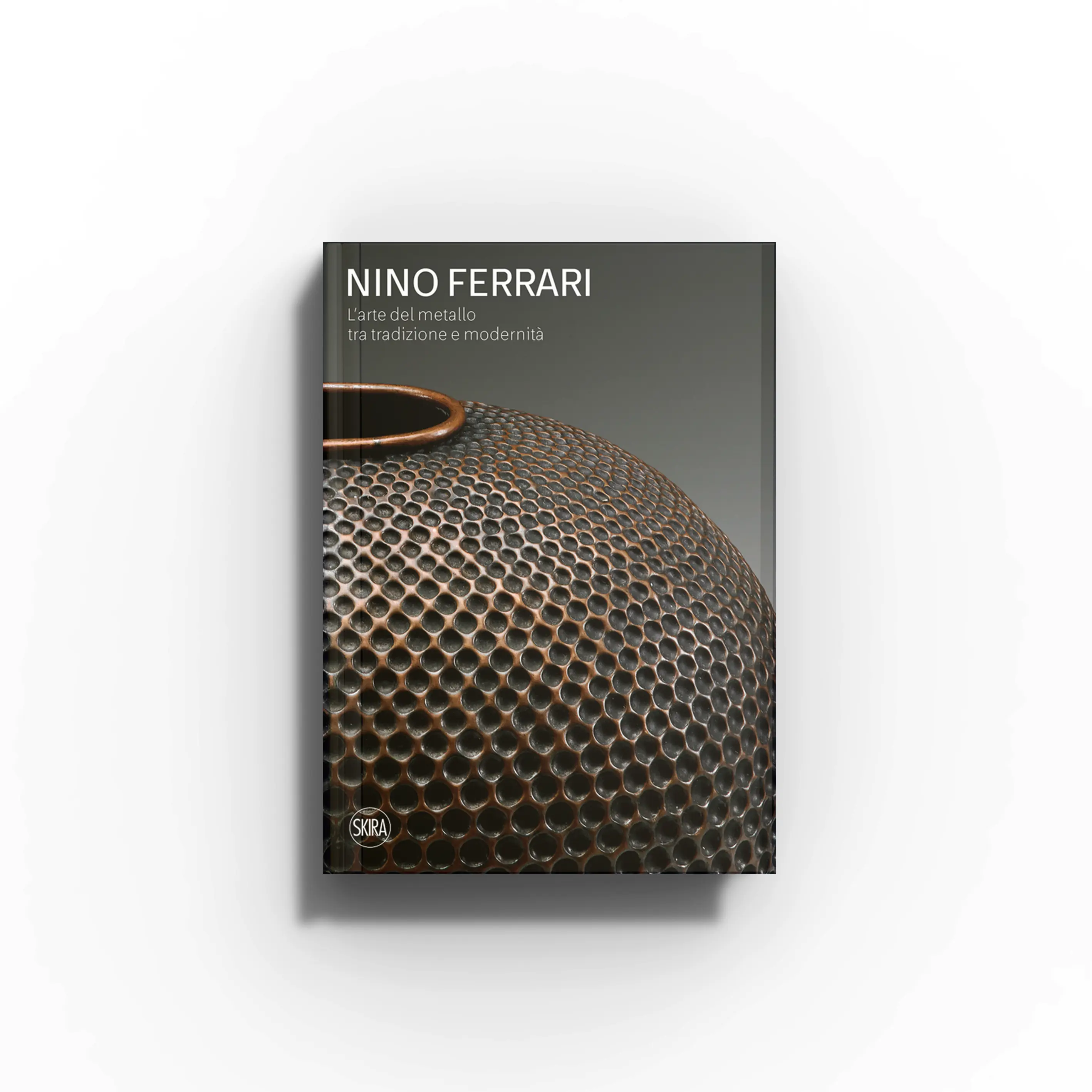 Decorative arts book by Skira Arte, Nino Ferrari, dark cover with metalwork pattern and handle detail