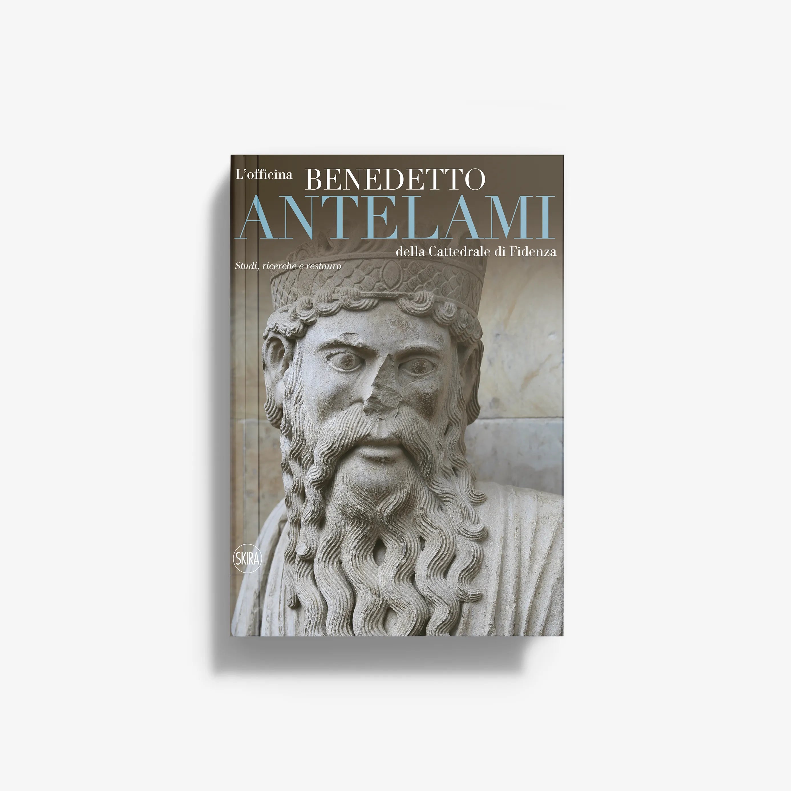Hardcover art book featuring a carved stone face cover with ornate beard