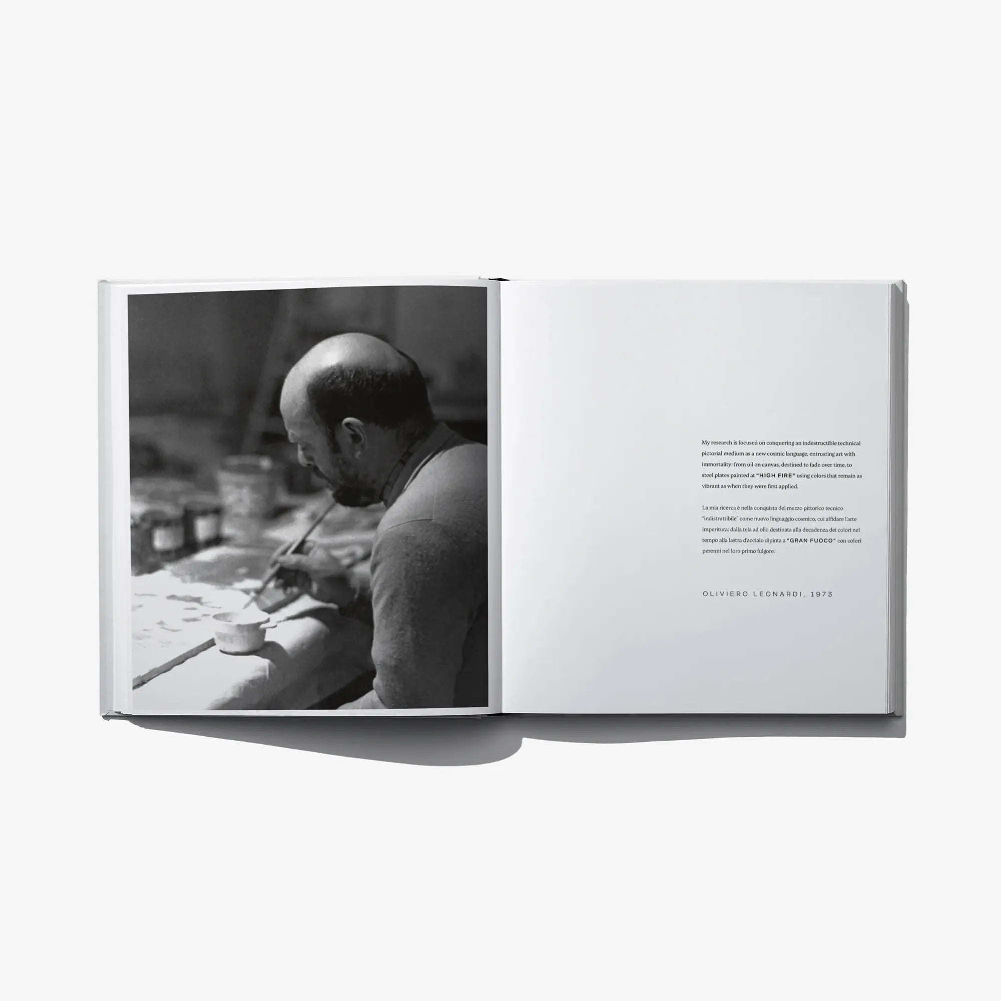 Open book with black-and-white studio photo on left and printed text on right
