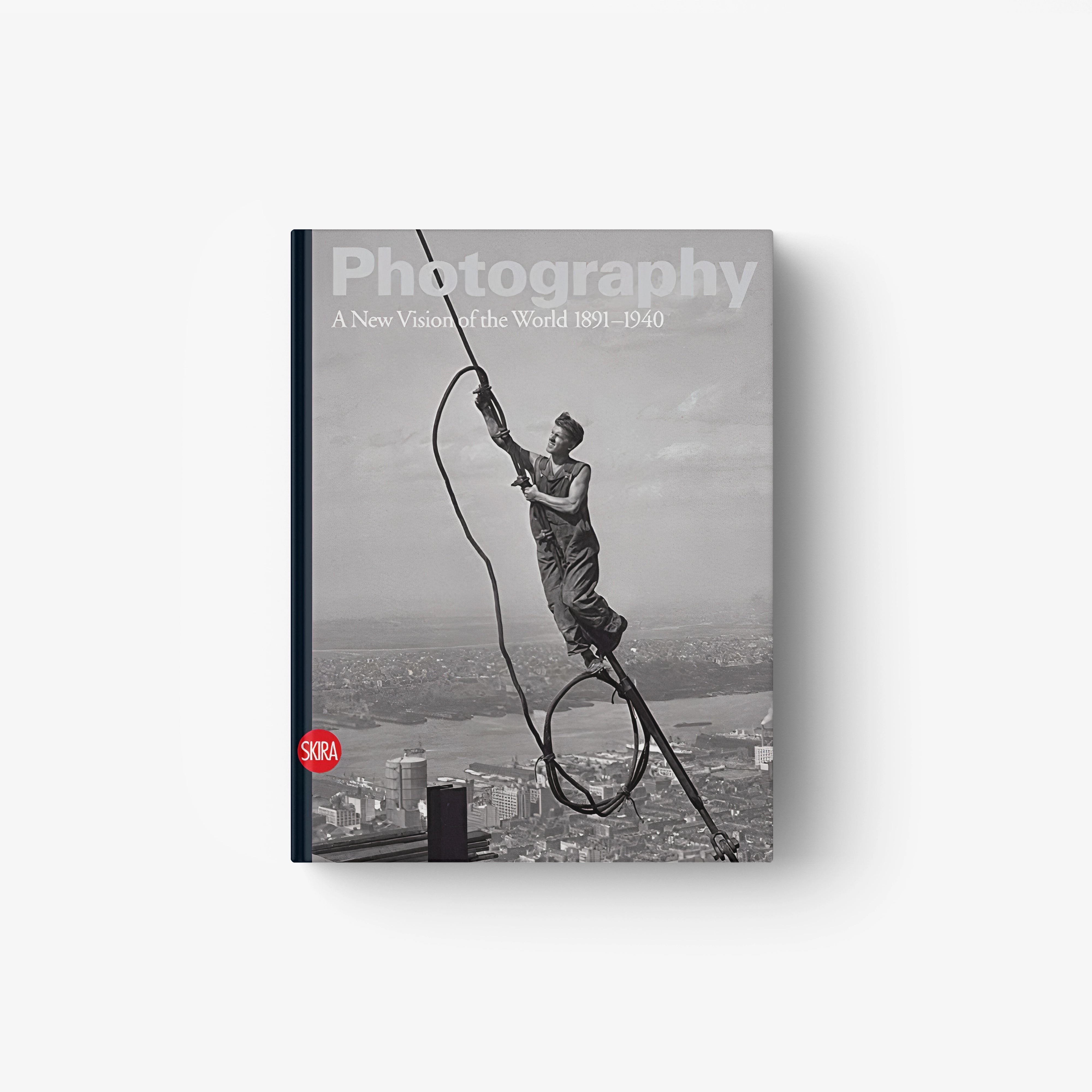 Hardcover photography book with grayscale cover photo of gymnast on rope, title text