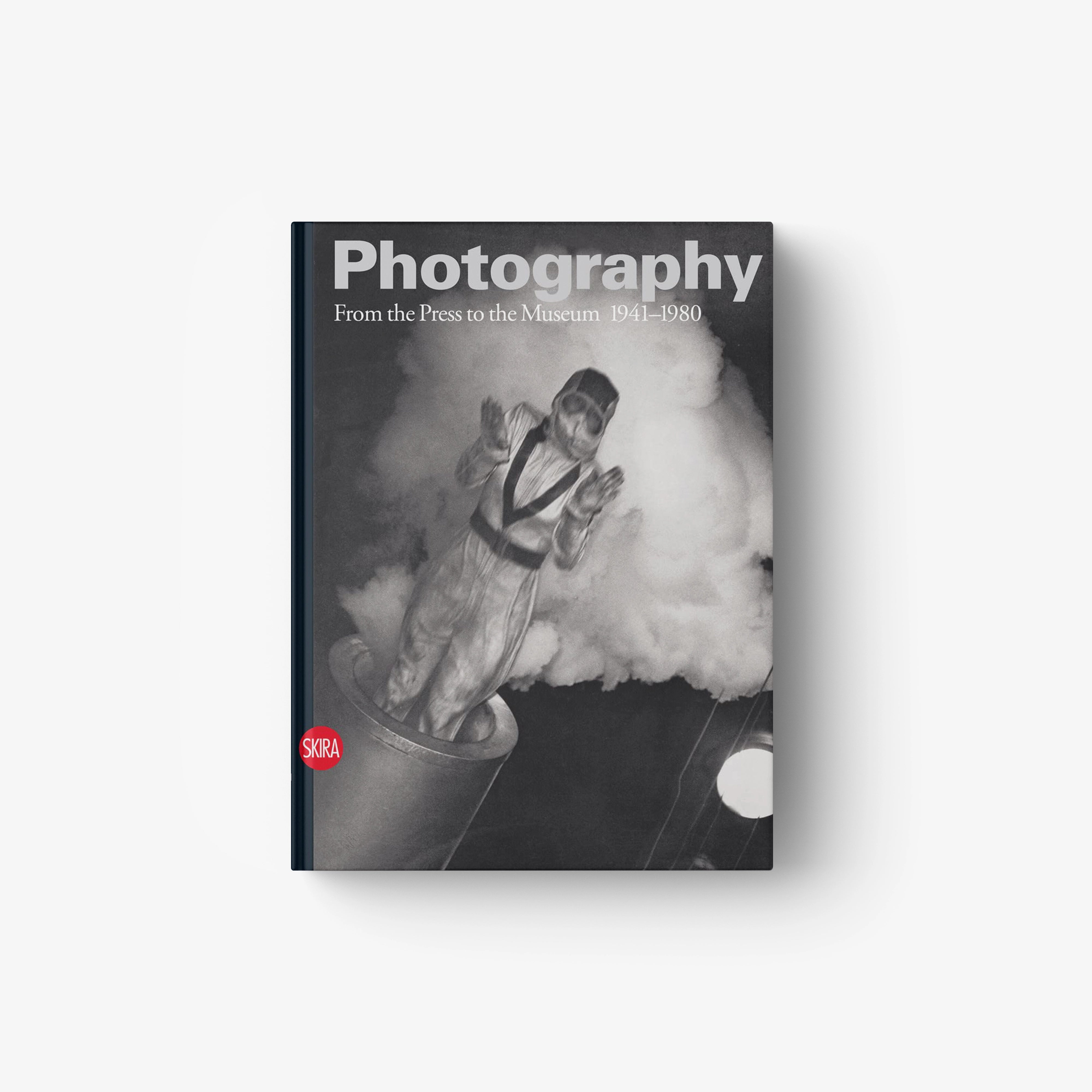 Hardcover photography book, monochrome cover with seated figure and title text