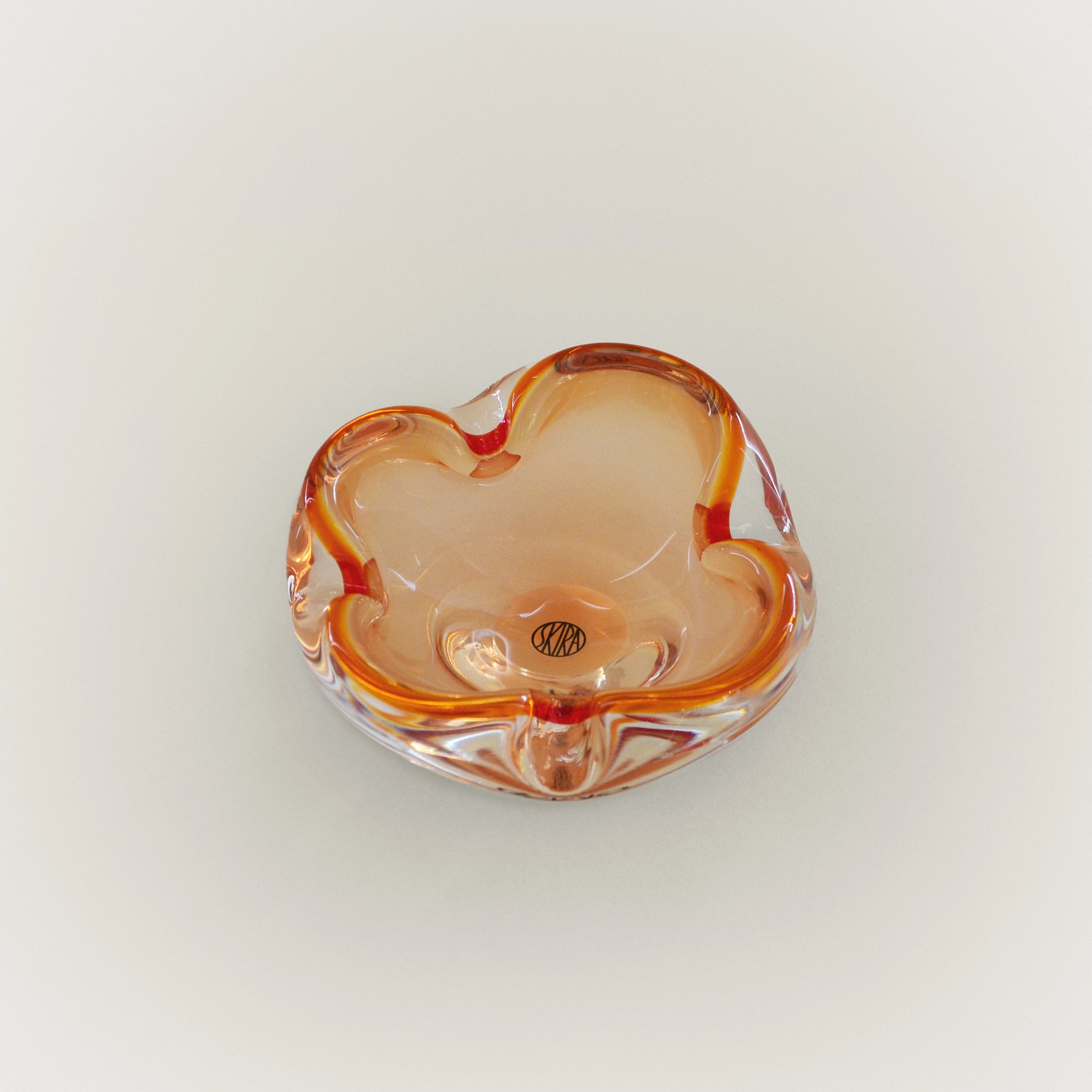 Orange-accented glass trinket tray with scalloped rim