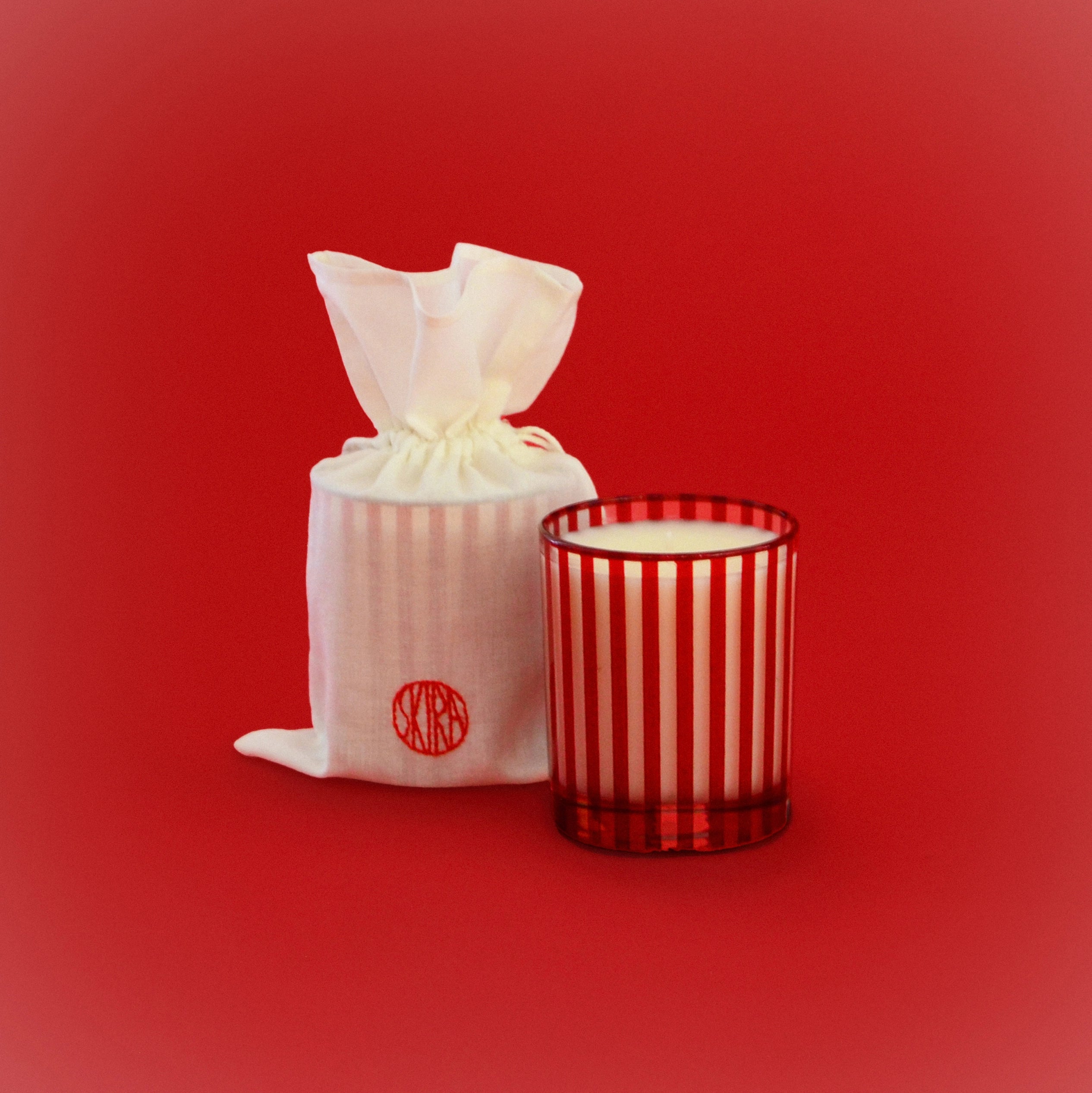 MERAVIGLI scented glass candle in red striped tumbler with visible wick