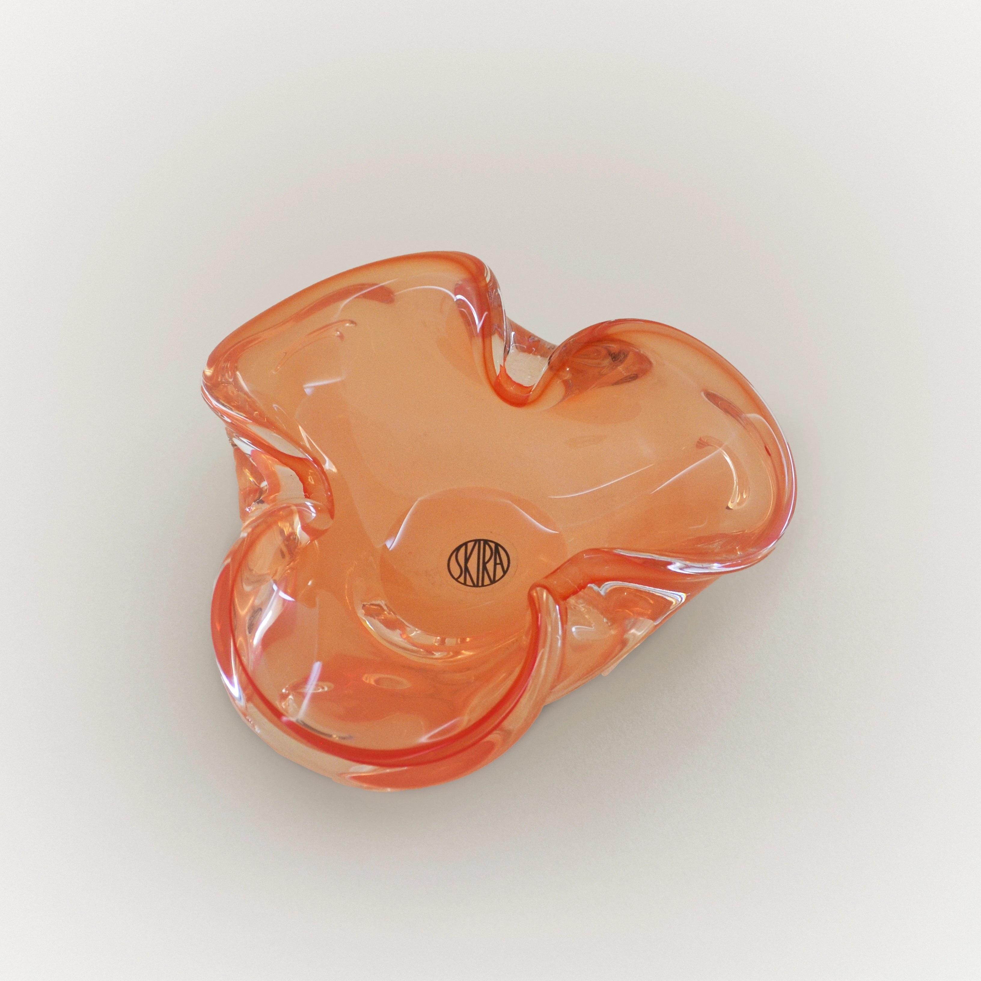 Sicilian orange glass tray with leaf-shaped design and SKIRA logo