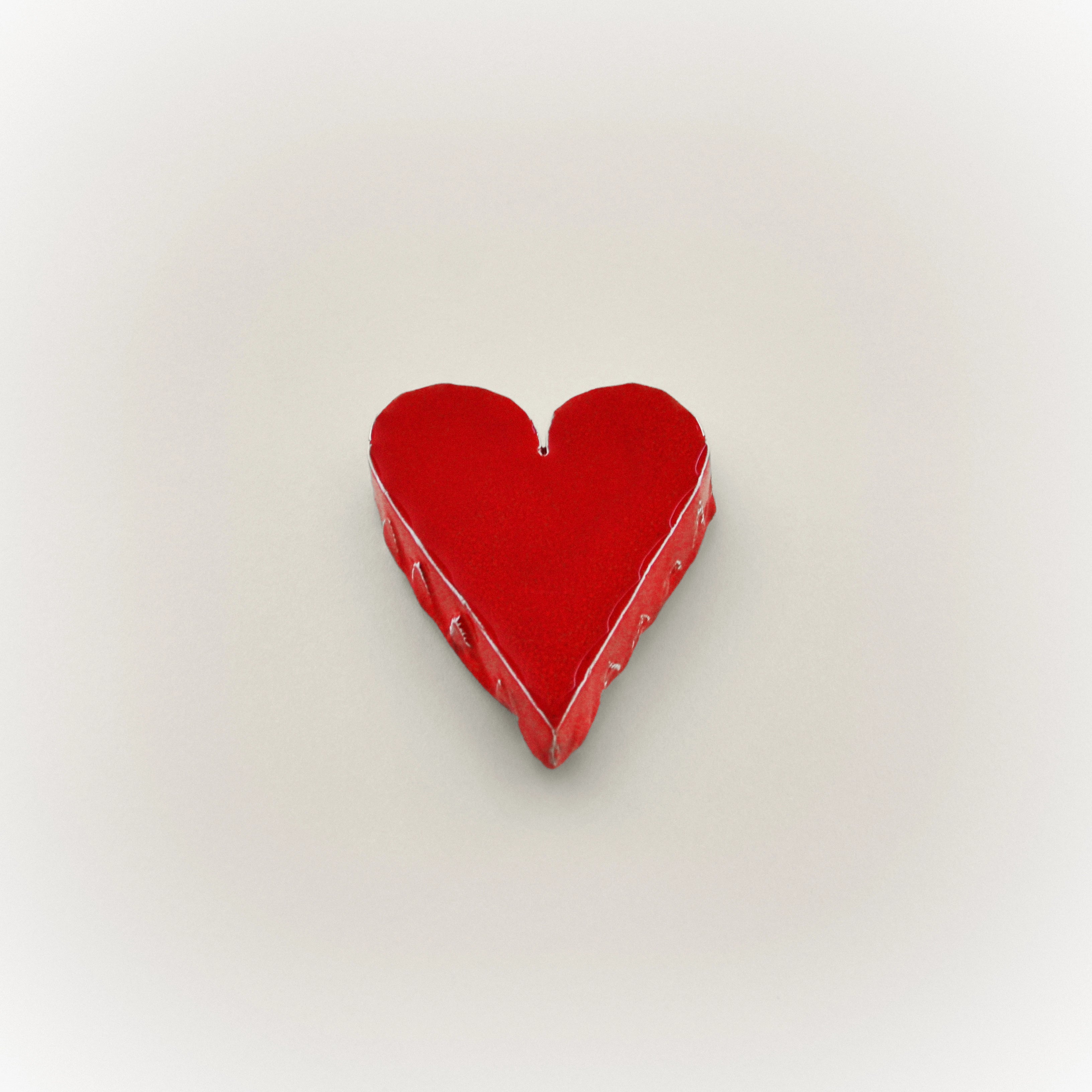 Red ceramic heart ornament with raised glossy heart shape