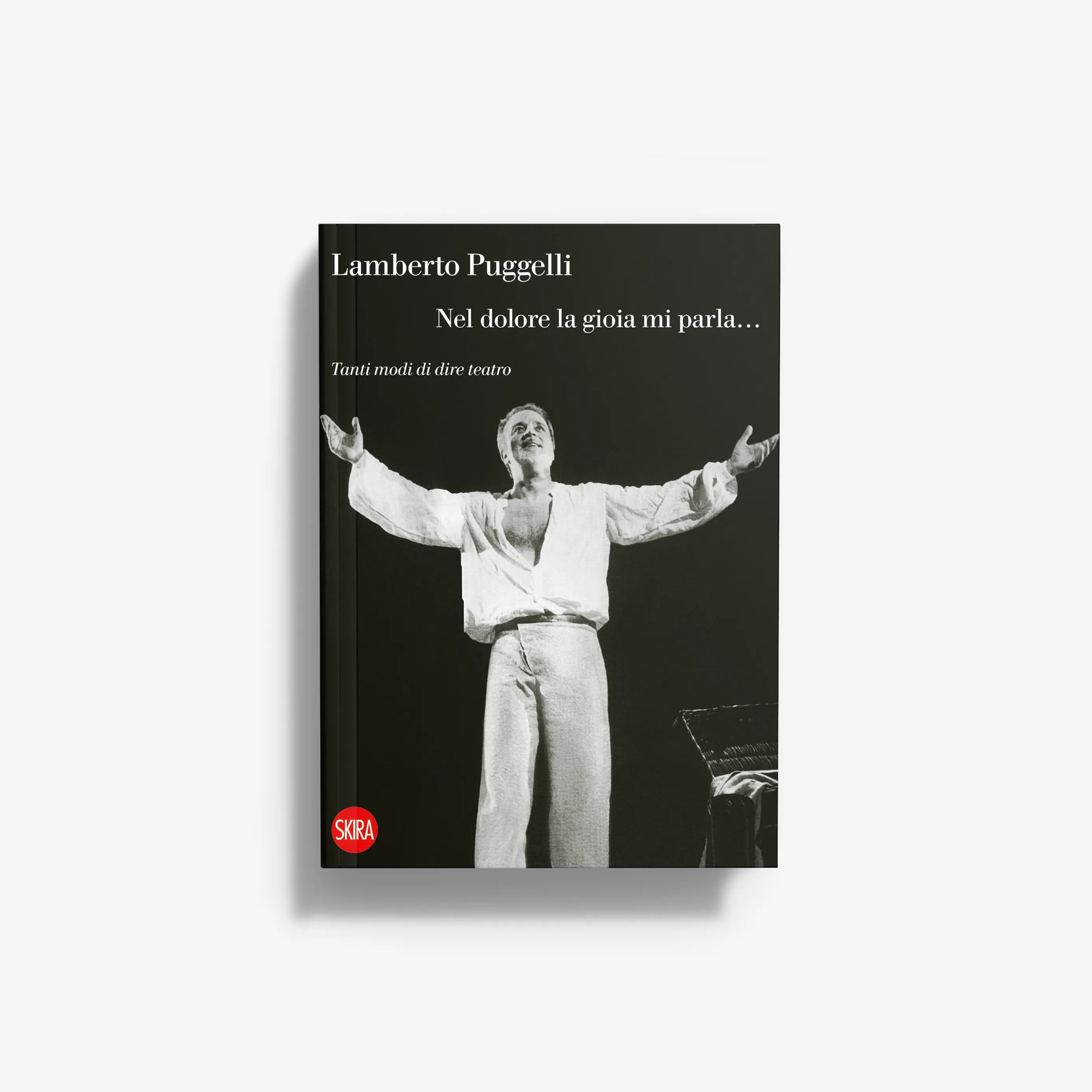 Hardcover book with dark cover and black-and-white figure illustration; Lamberto Puggelli.