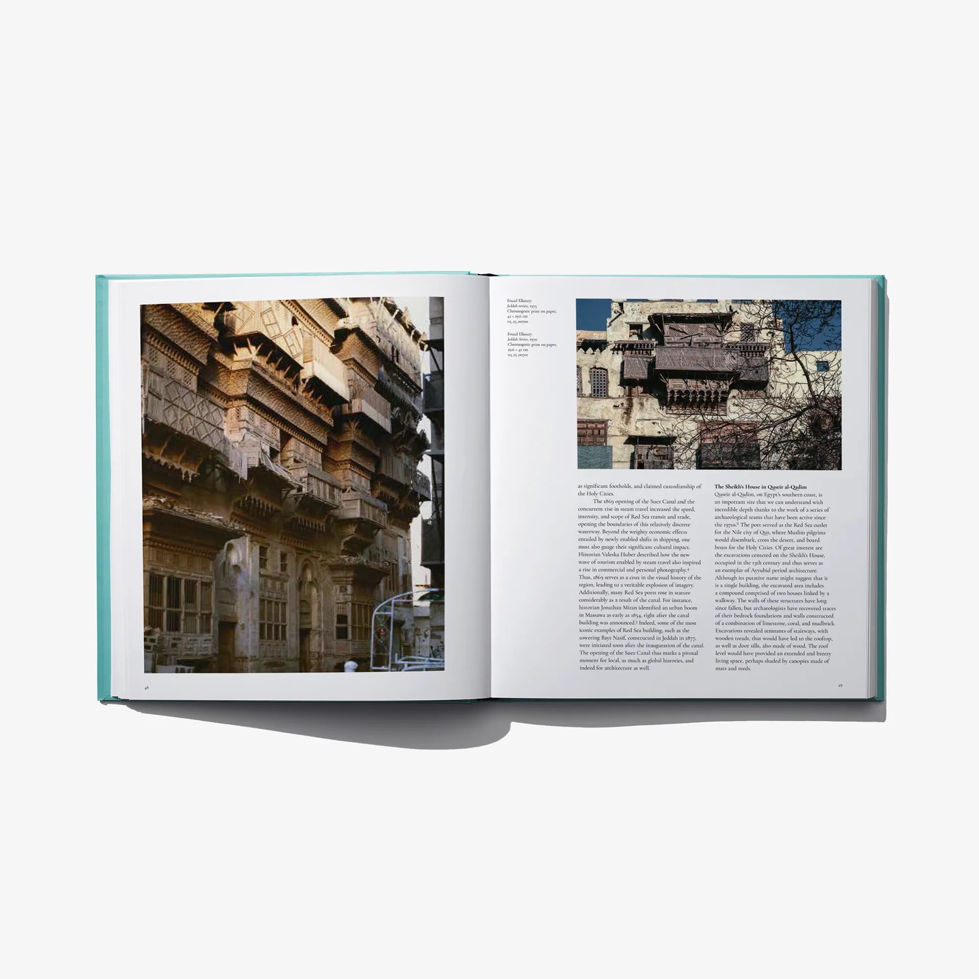 Open museum book spread with interior photos and text blocks on off-white pages