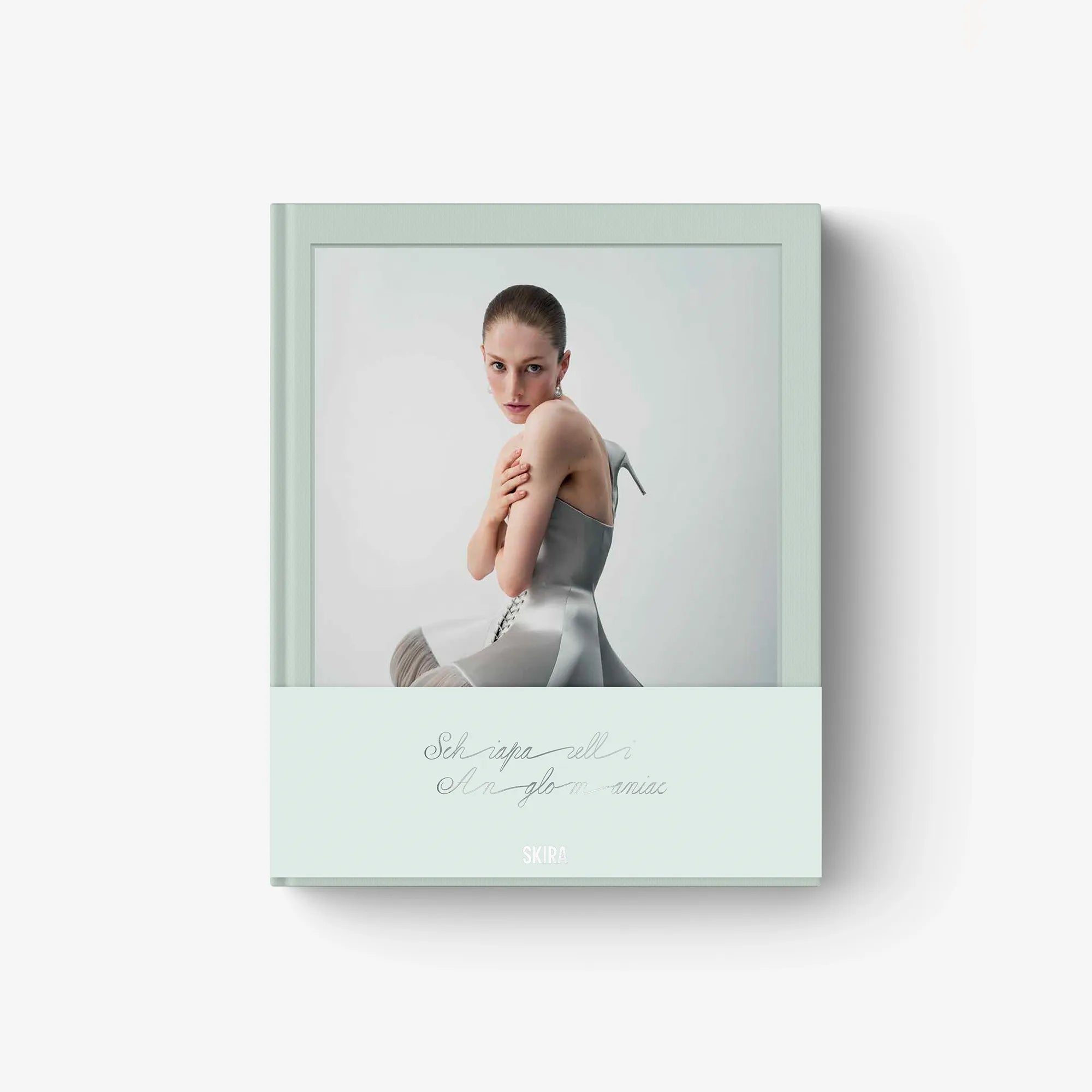Fashion catalog cover with model in a gray dress, SCHIAPARELLI ANGLOMANIAC