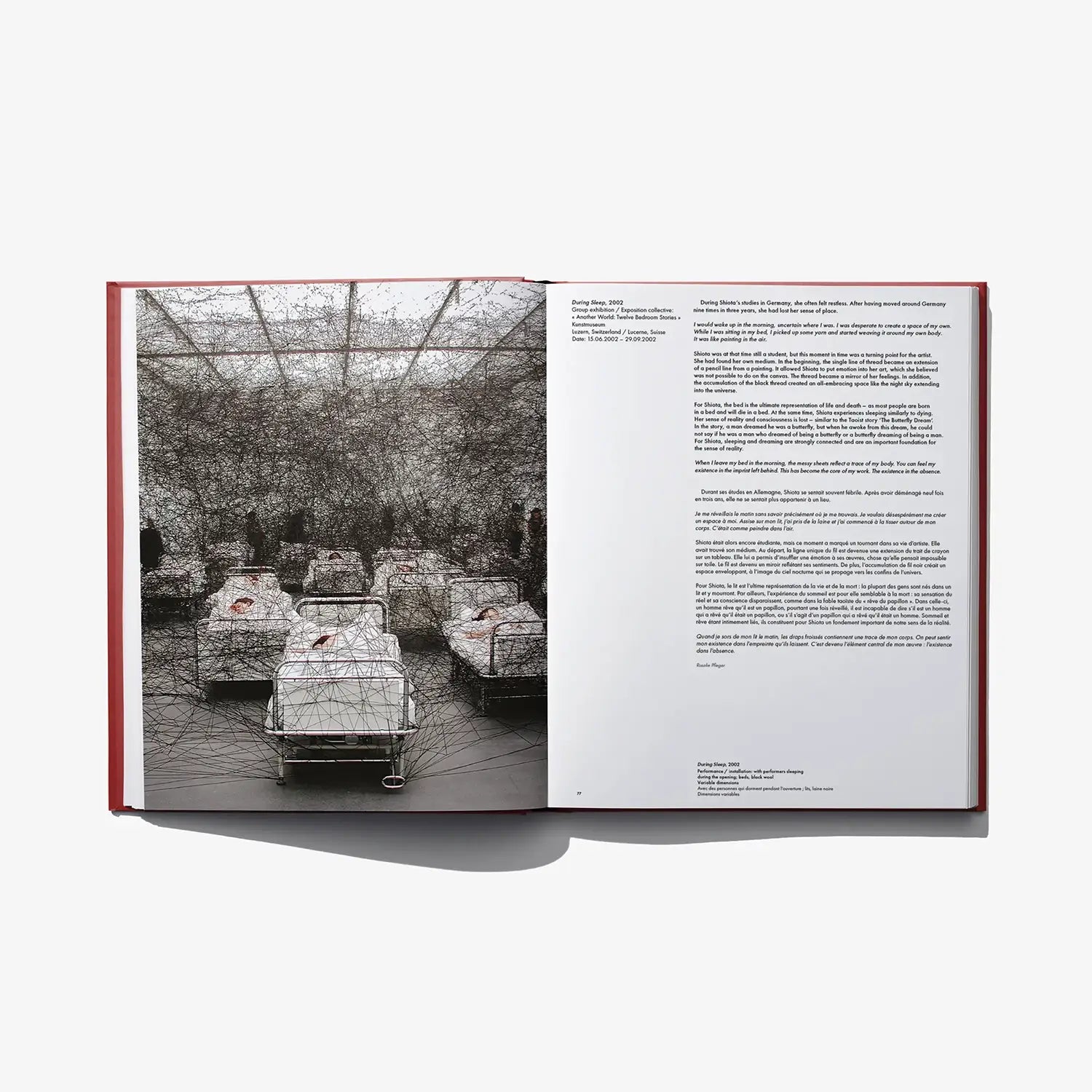 Open art book spread with black-and-white installation photo on left and text page on right