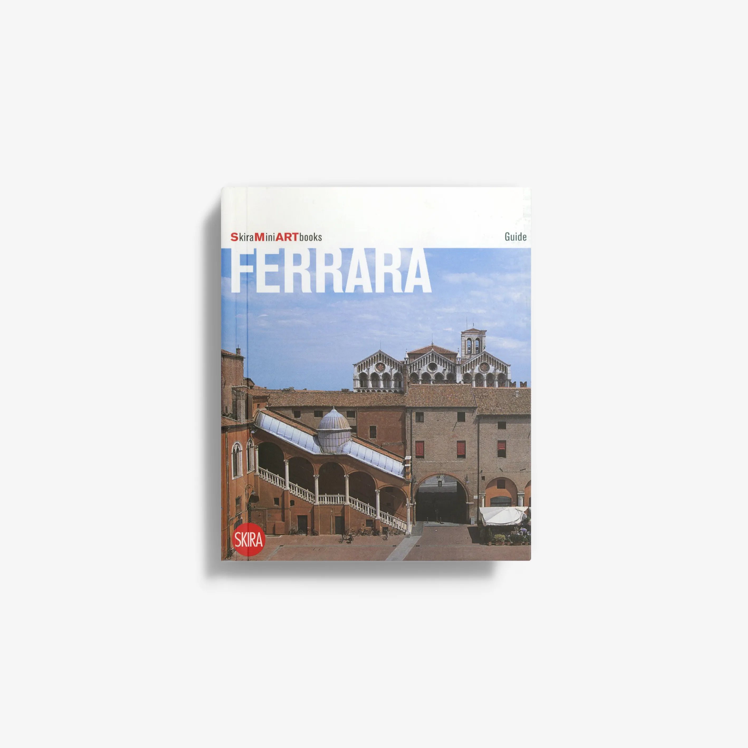 Ferrara art guidebook with city skyline cover and blue sky
