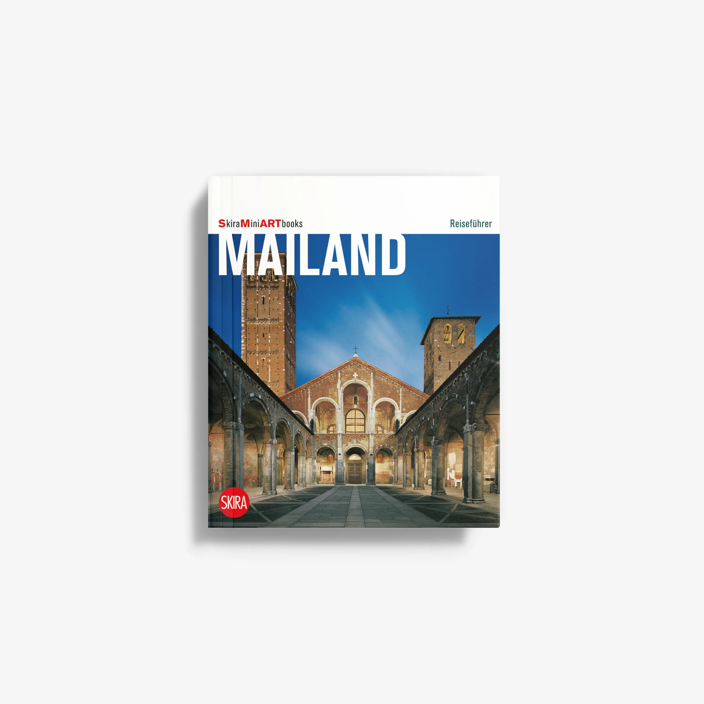 Paperback travel book with blue city architecture cover, titled Mailand