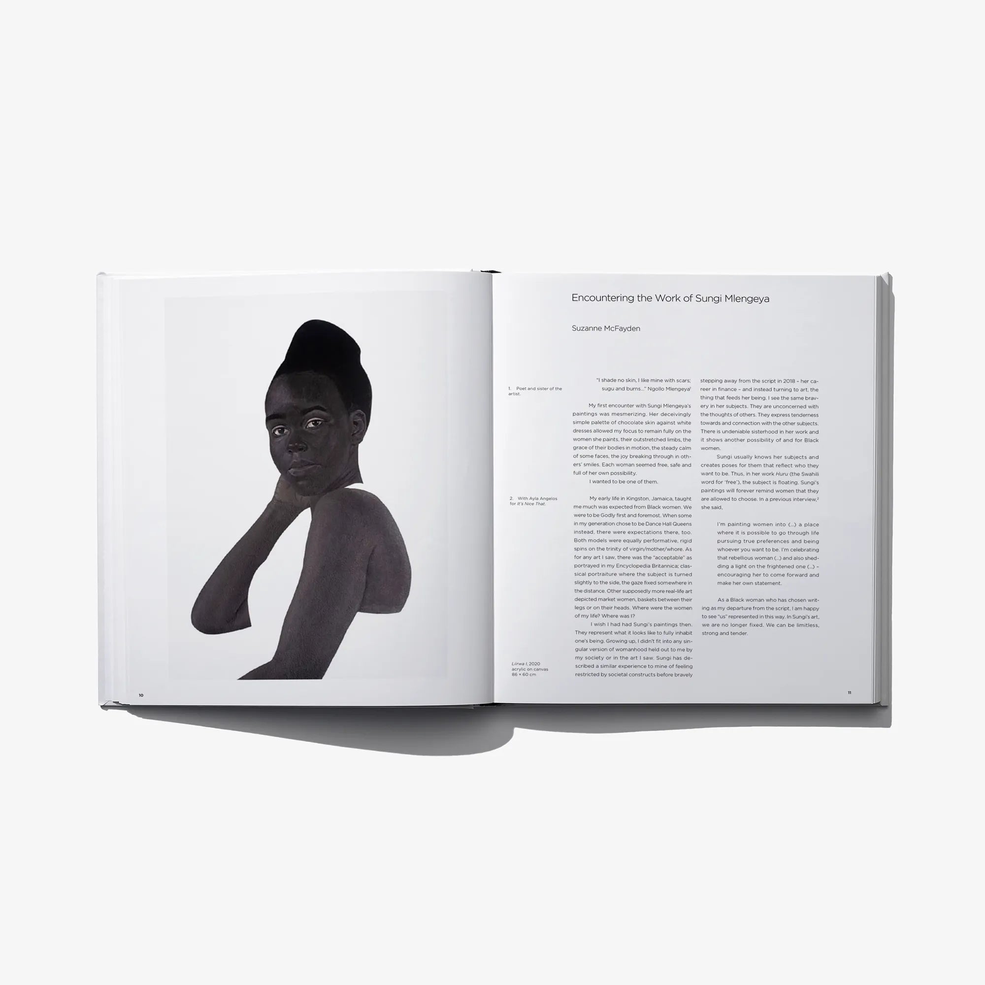 Art photo book open spread with black-and-white figure portrait and caption text