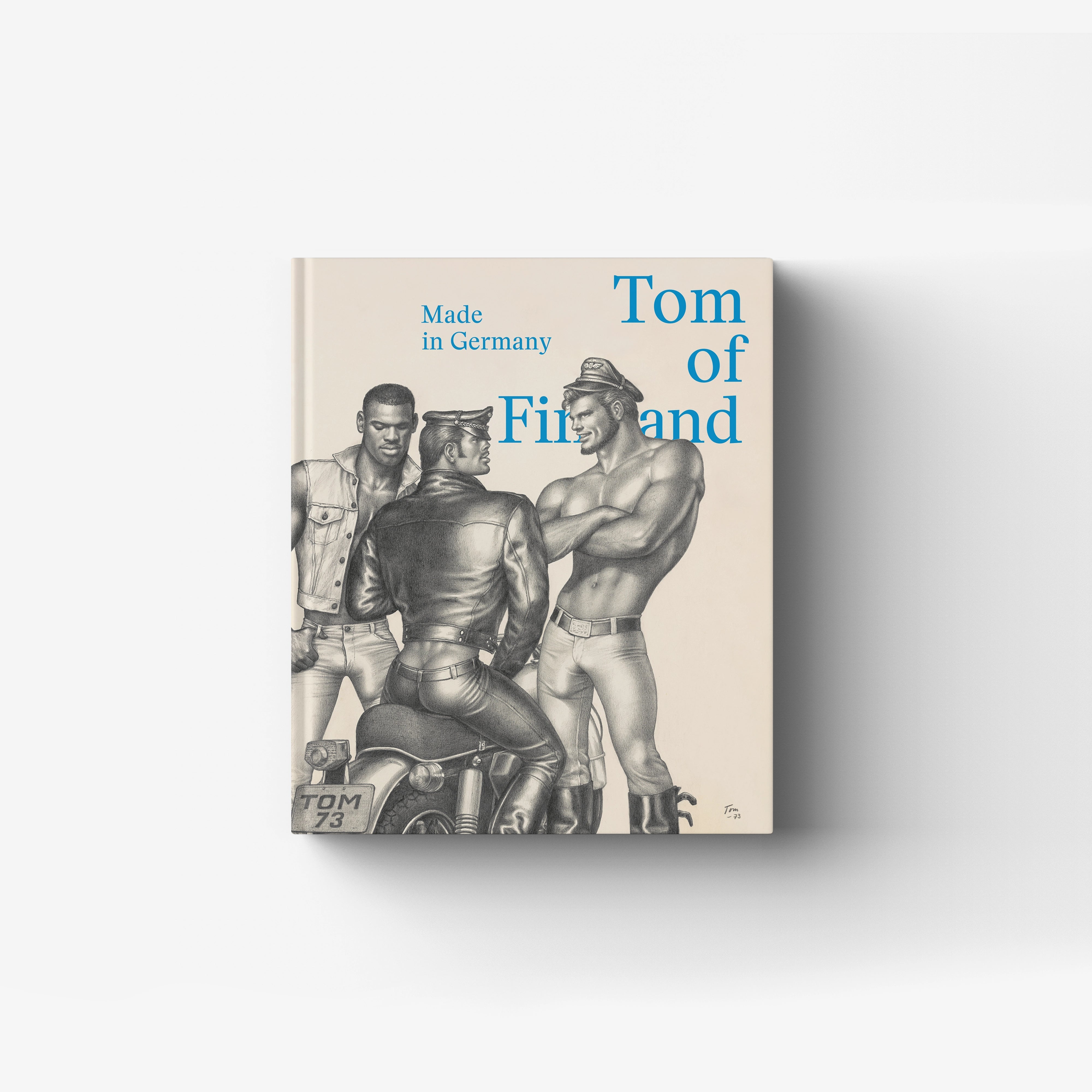 Hardback art book with blue title text and black and white figures, Skira Arte, Tom of Finland Made in Germany