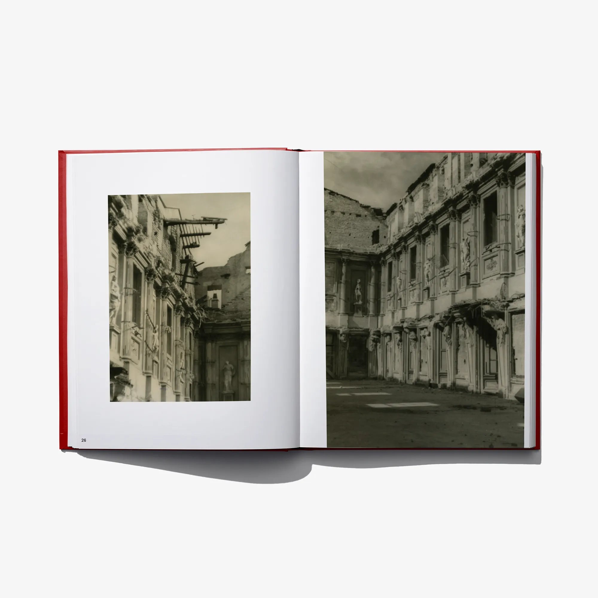 Open photo book spread with black-and-white city building photographs on both pages