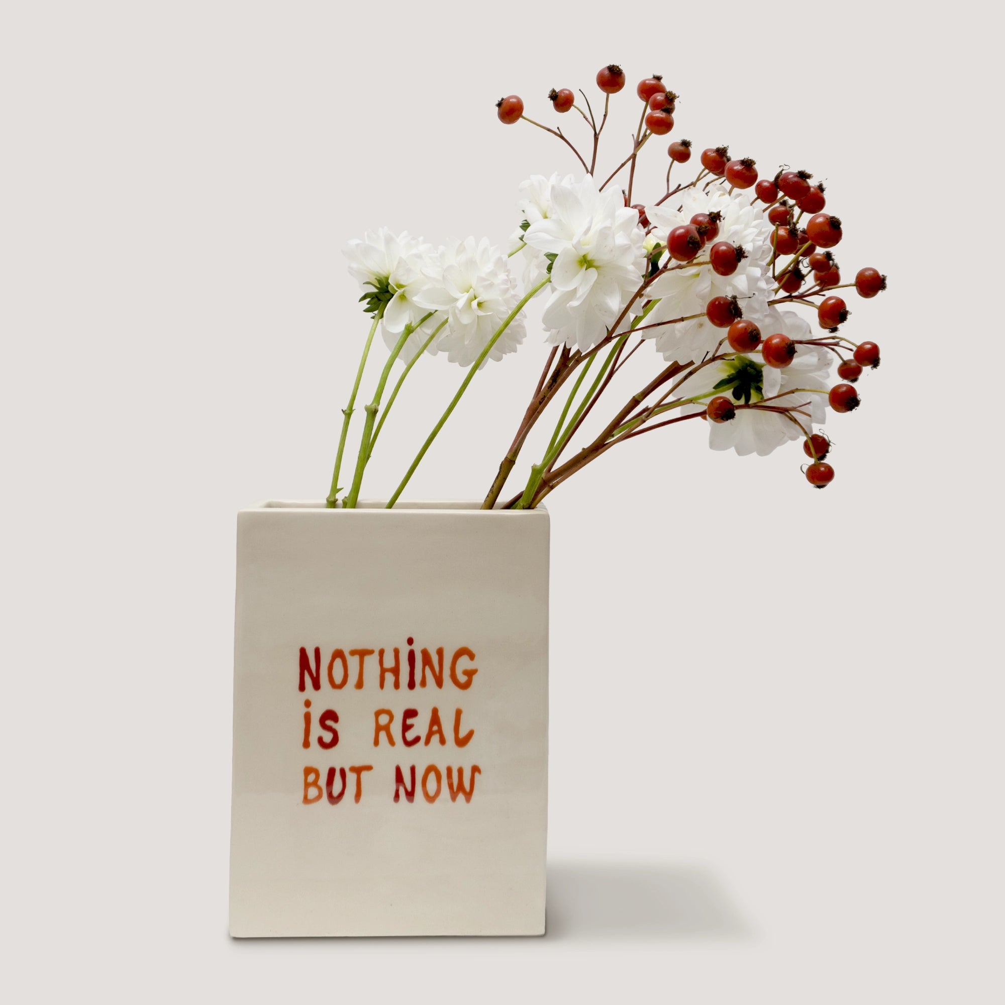 Handmade ceramic vase with square shape and red 'NOTHING IS REAL BUT NOW' text