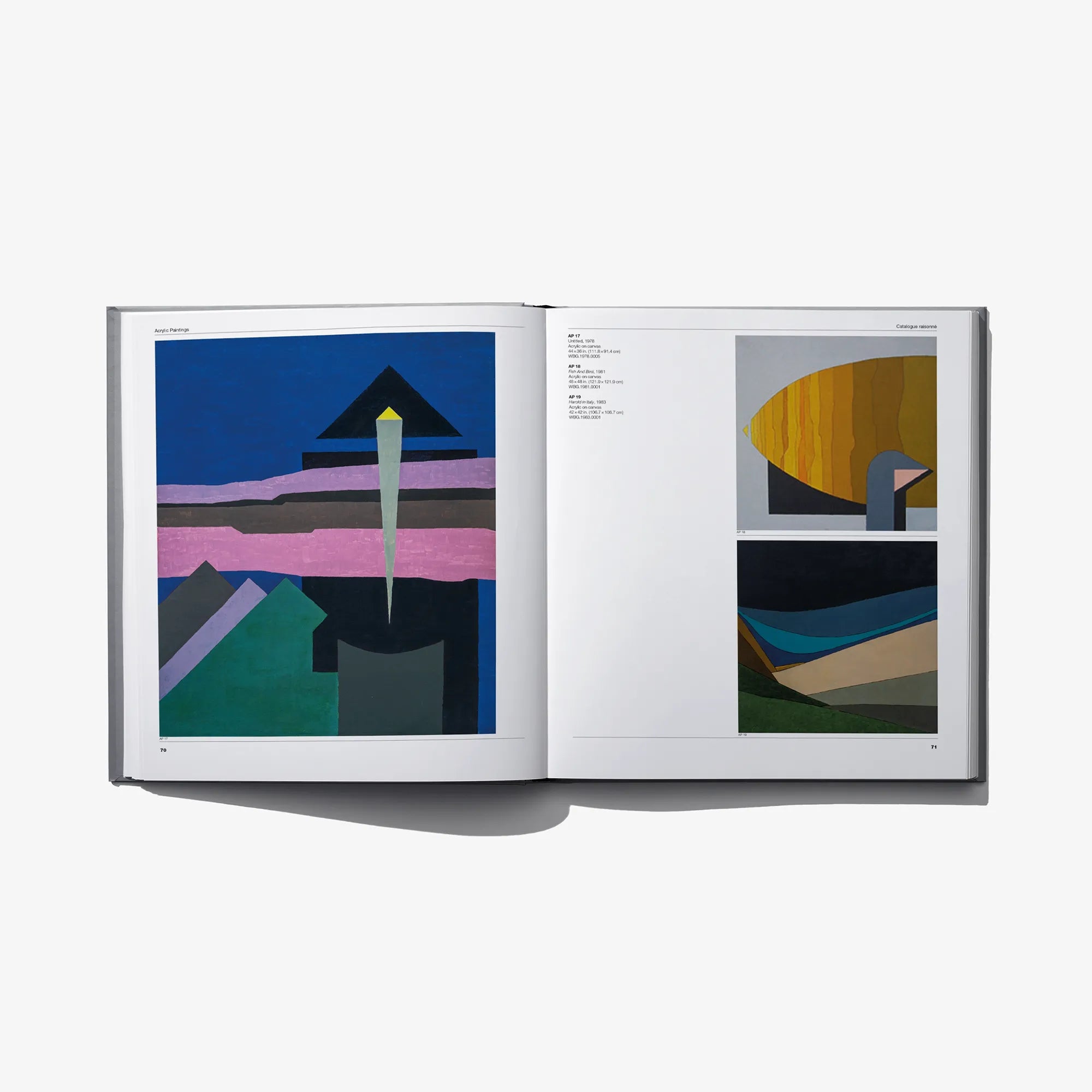 Open art catalog with abstract geometric artwork on two pages