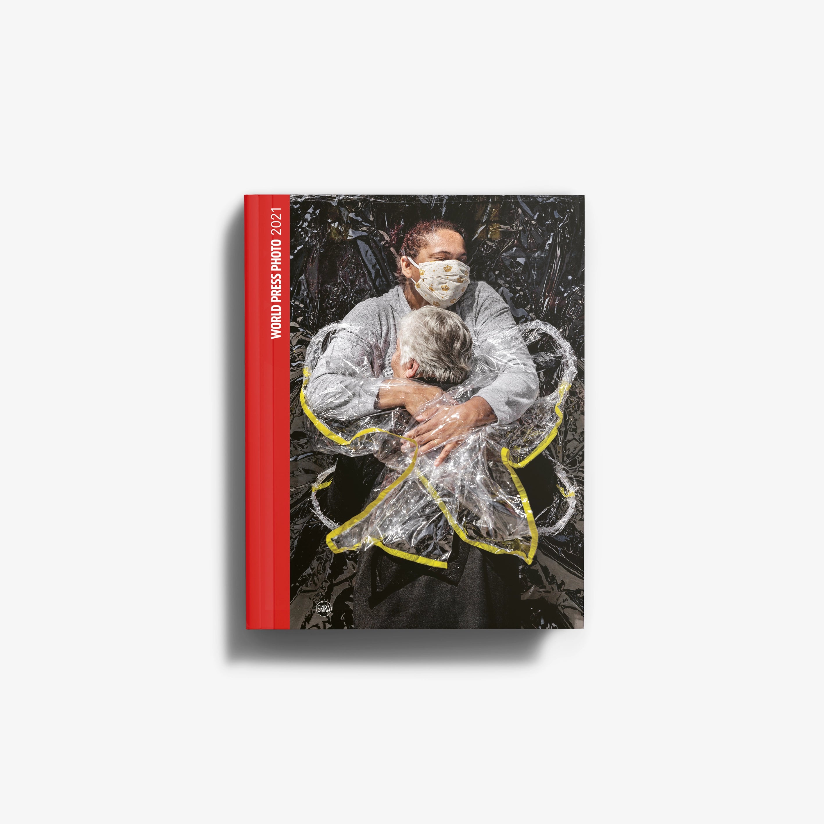 Photojournalism catalogue World Press Photo 2021 by Skira Arte, red spine, cover shows masked healthcare worker and patient