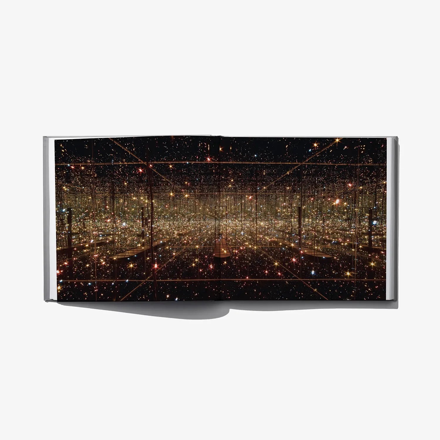 Open art book spread with dark starry dot grid and glowing lines