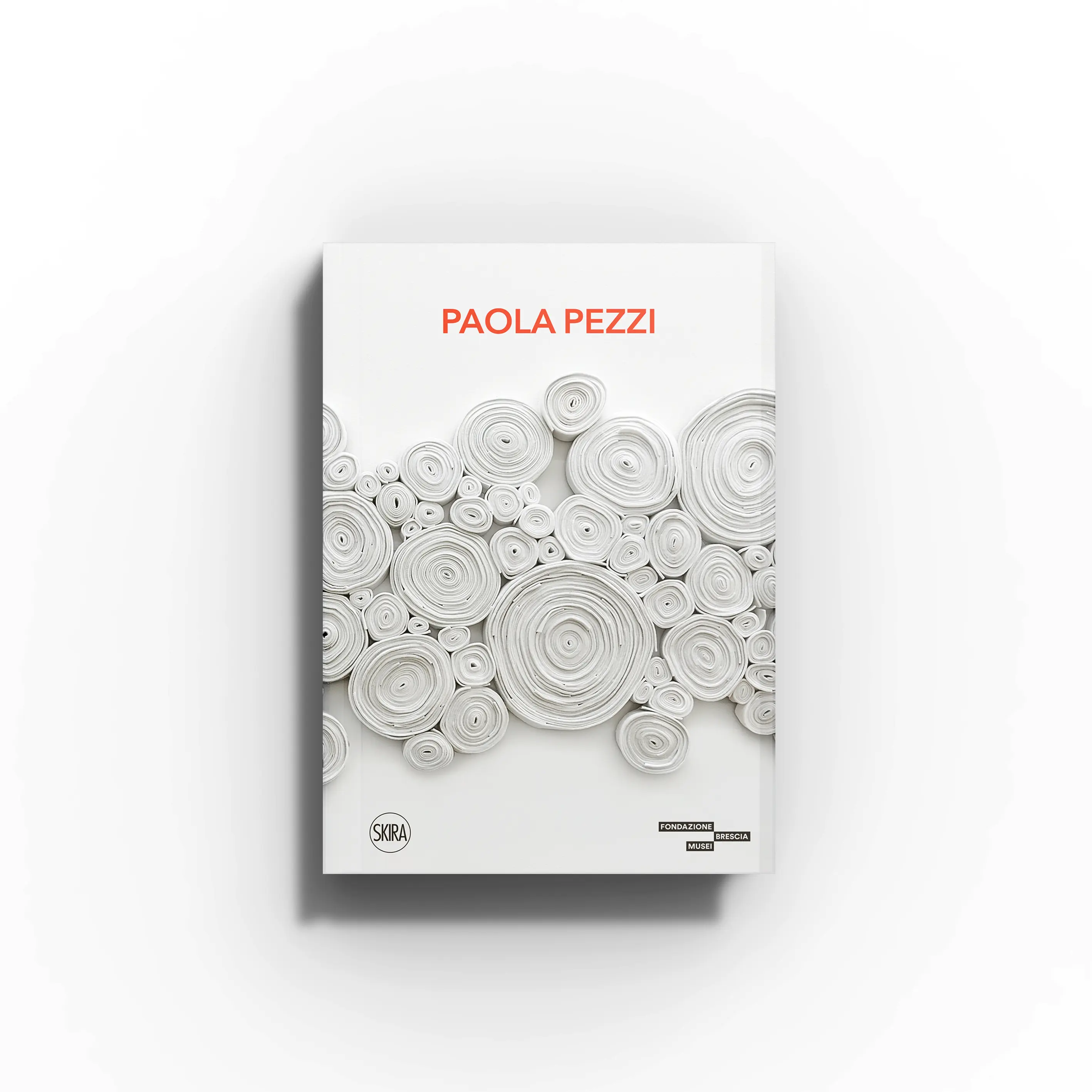 Contemporary wall sculpture by Skira Arte, Paola Pezzi Spellbound, with white rolled fabric forms and orange title text
