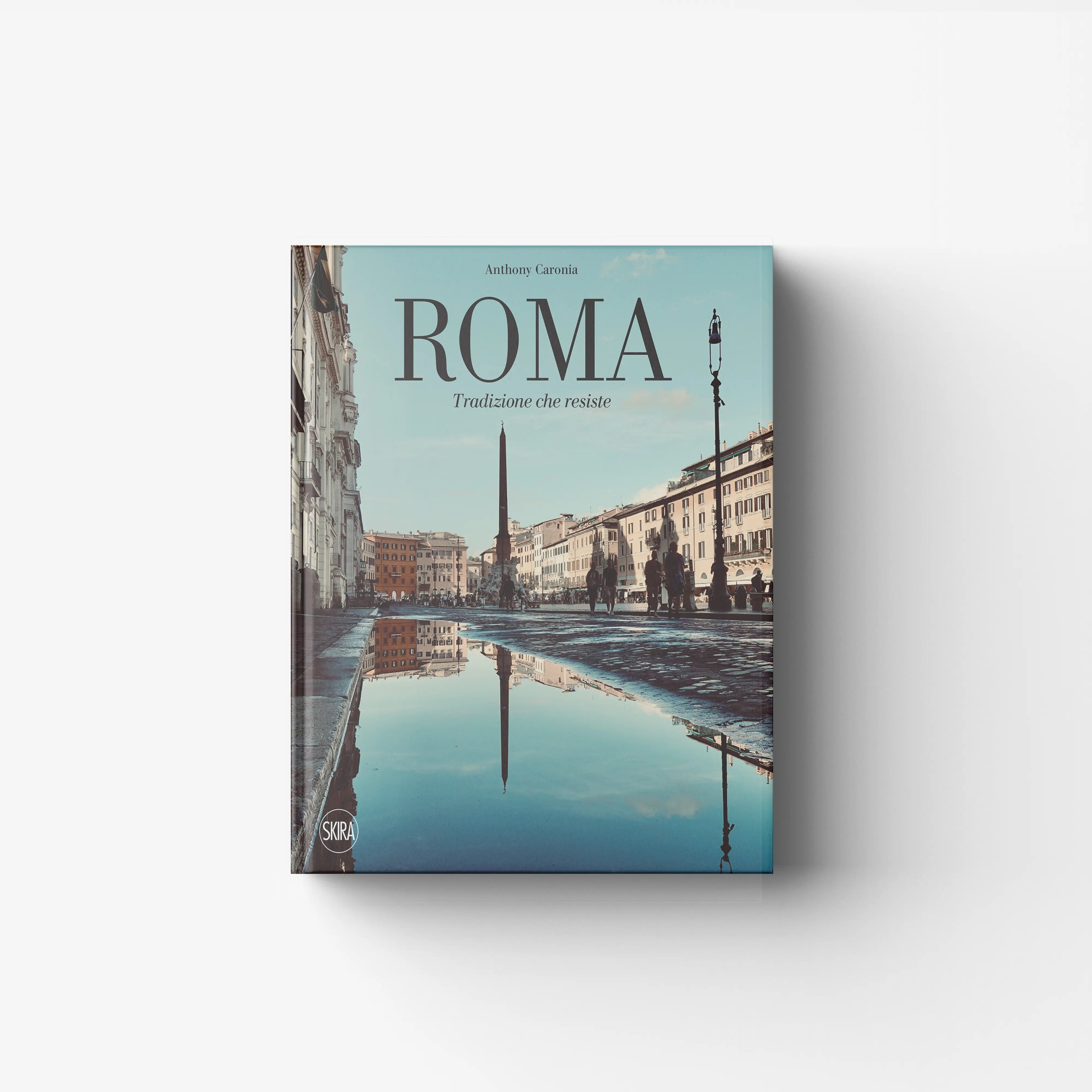 Hardback book by Skira Arte titled Roma, with illustrated pages and a pale blue cover featuring city views